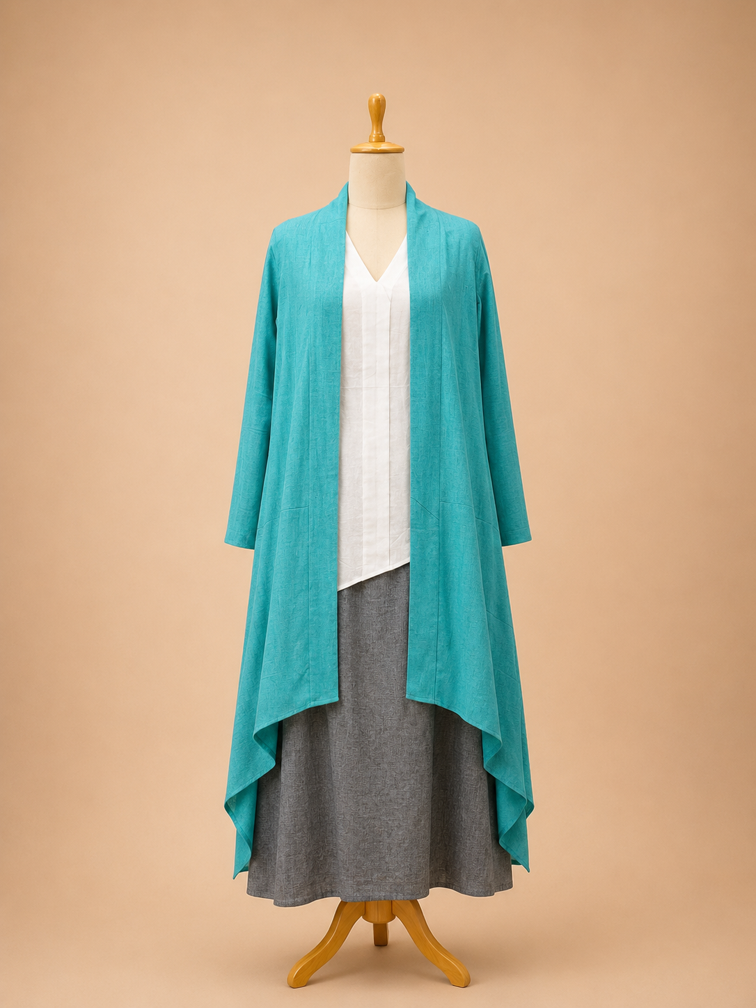 Three-piece ensemble featuring a boho ankle-length skirt, sleeveless tunic, and asymmetrical long-sleeve cape by Bohe by NAM.